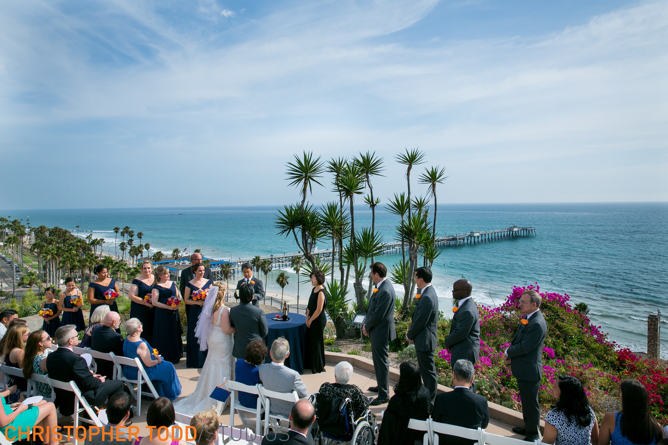 Beautiful outdoor wedding ceremony at Casa Romantica in Orange County overlooking the ocean and San Clemente Pier.