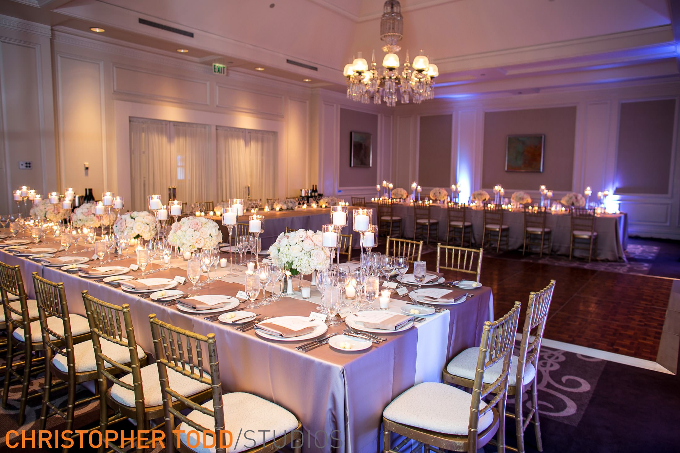 reception with long tables and white cushion chairs with gold backing at ritz laguna niguel.