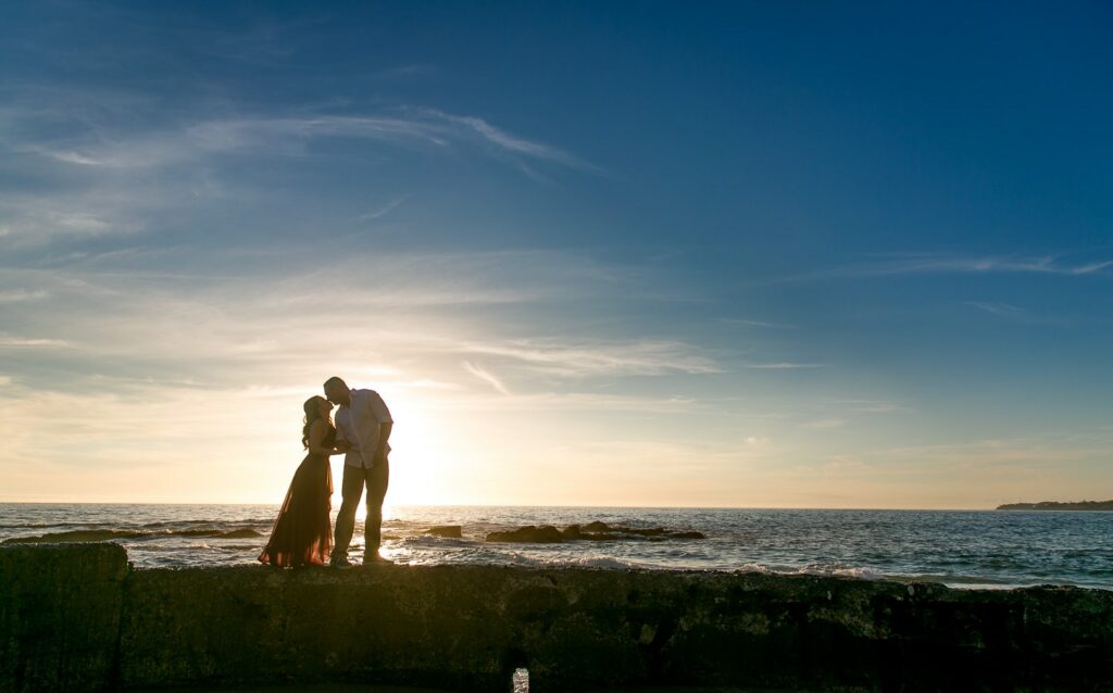 silhouette of couple kissing as sunsets at victoria beach in laguna.