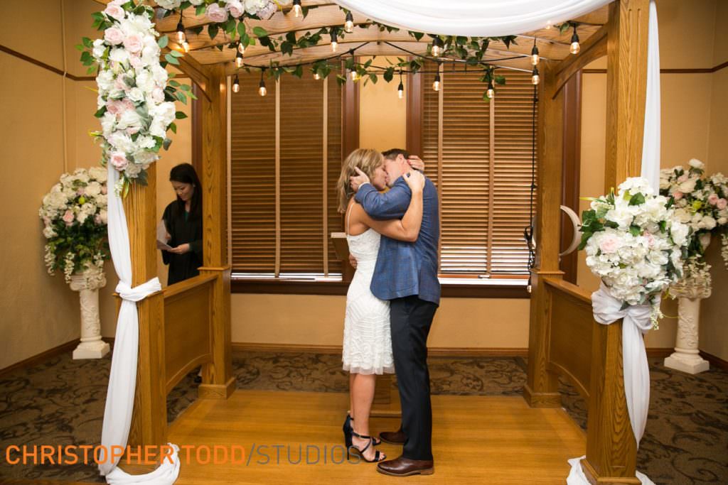 Couple's first kiss at their civil ceremony at the old courthouse in santa ana.