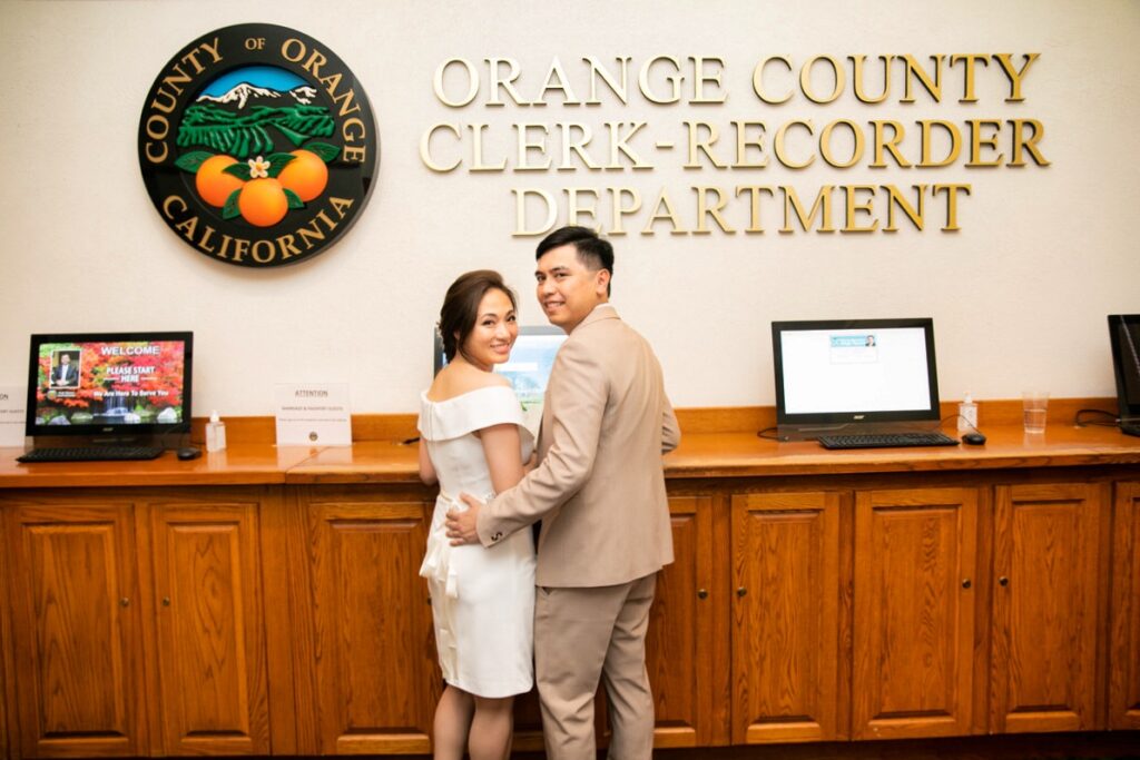 couple signing marriage certificate in the orange county clerk recorder office in santa ana