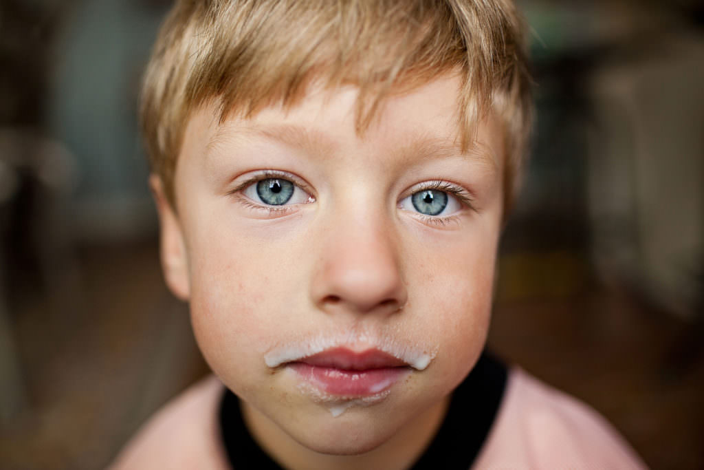 portrait of small boy with milk mustache