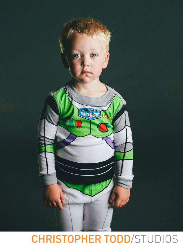 Studio portrait of toddler in buzz lightyear pajamas.