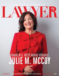 OCBA cover of female attorney wearing red suit.