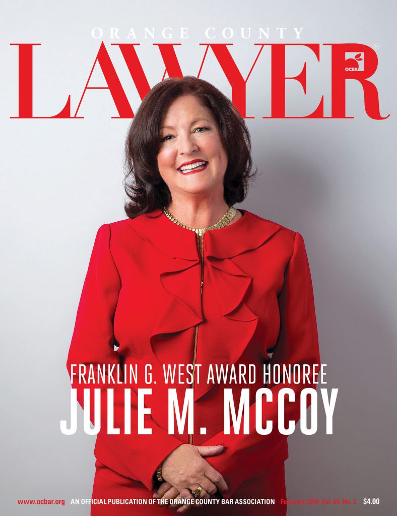 OCBA cover of female attorney wearing red suit.
