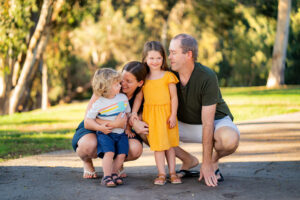 Candid family portrait in park with small children