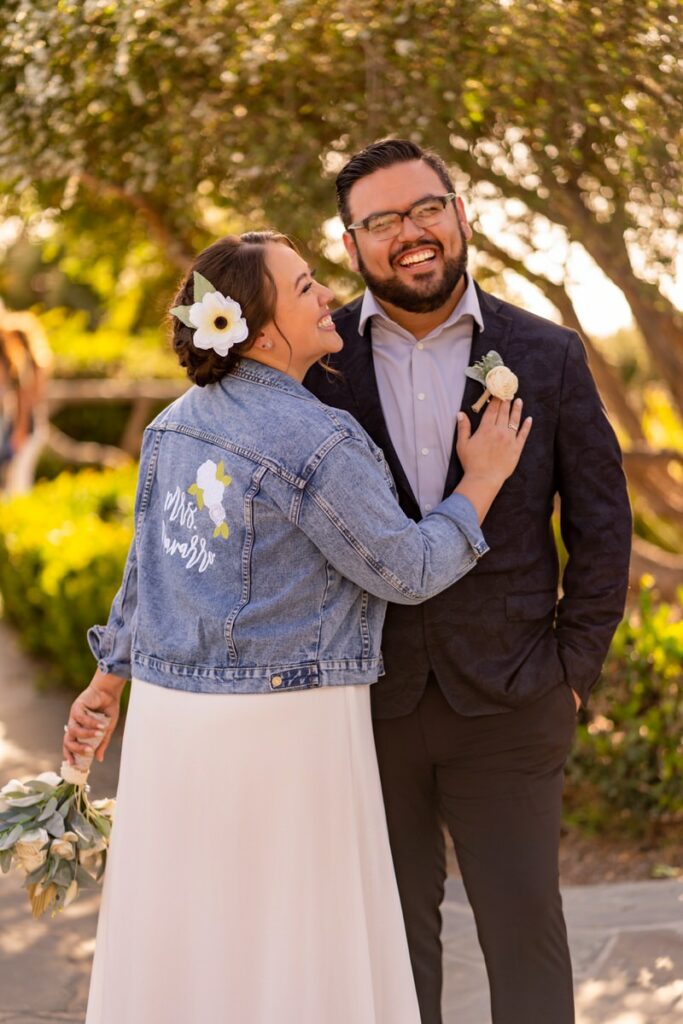 Elopement photo with bride wearing custom jean jacket