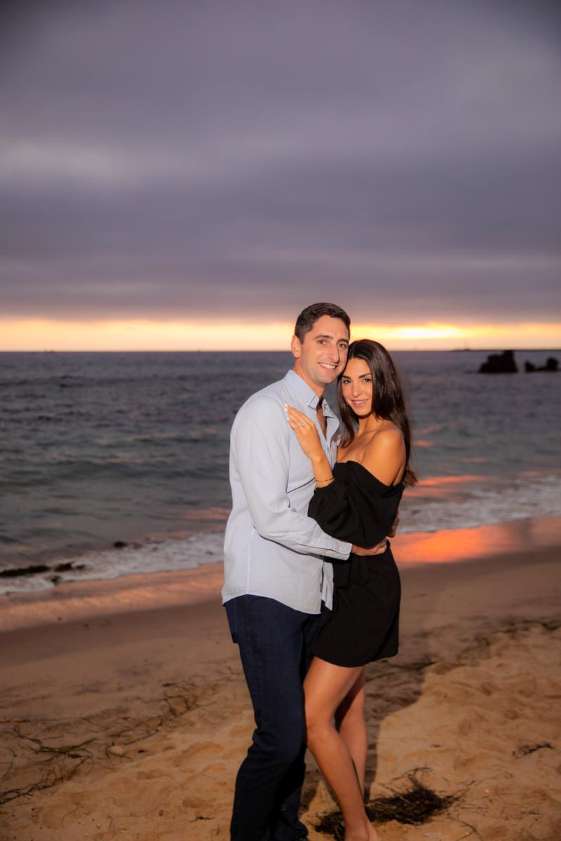 surprise marriage proposal on beach during sunset