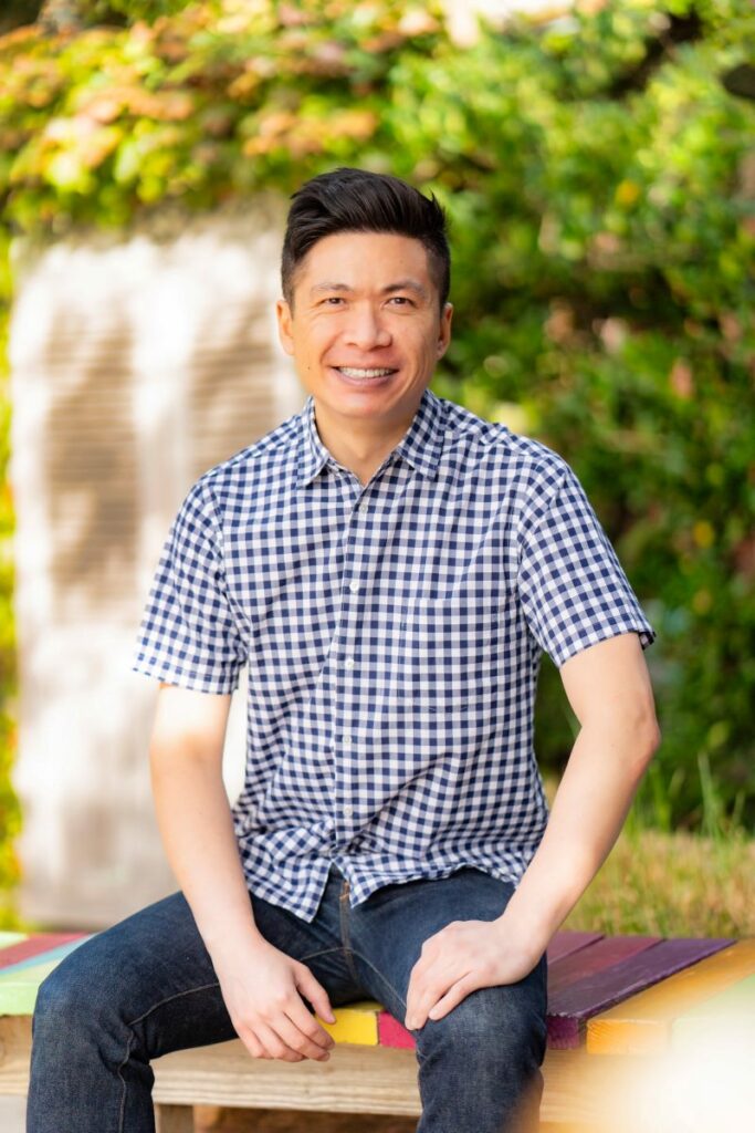 Guy's dating profile comes to life in a professionally shot outdoor photo, highlighting his casual outfit with a classic short sleeve button down shirt.