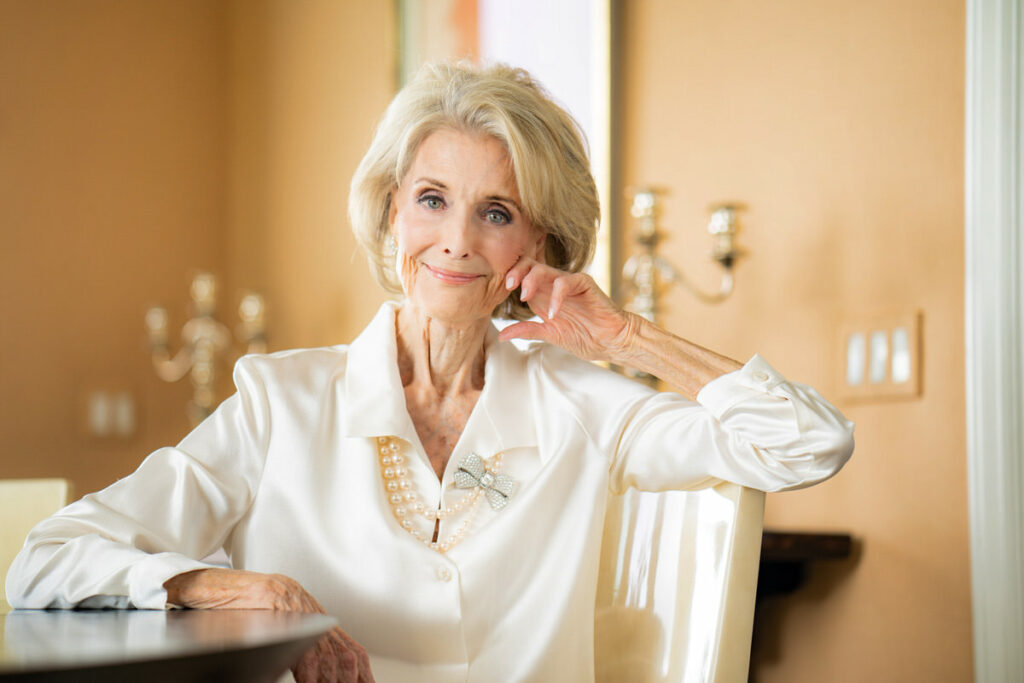 Older women wearing off white blouse