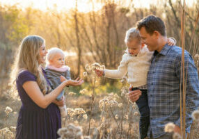 young family picking flowers during photo session